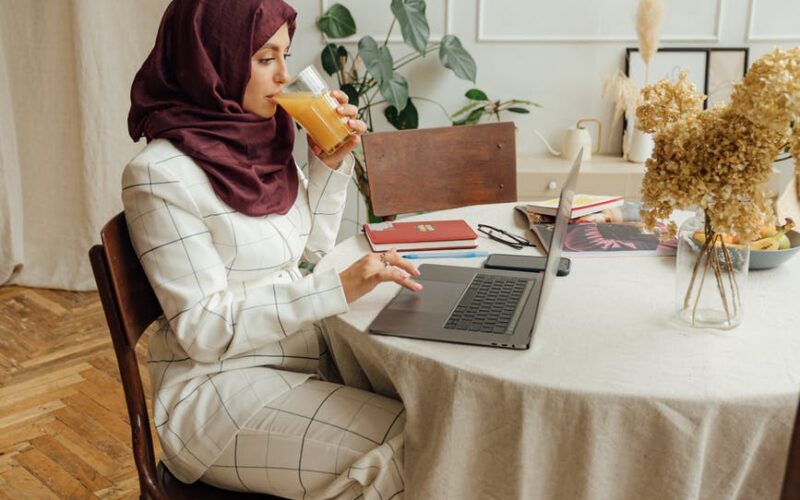 woman in a hijab using a laptop
