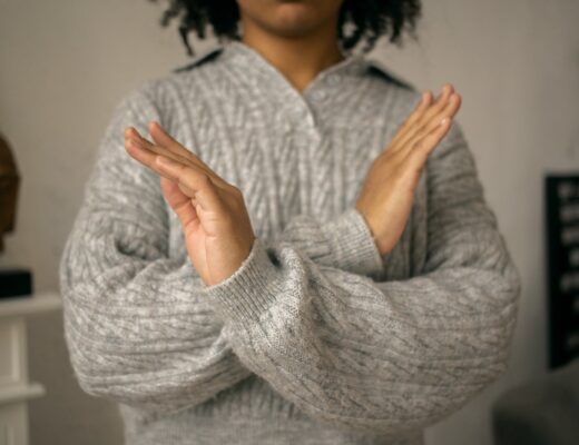 calm black woman crossed arms as restriction sign in light room